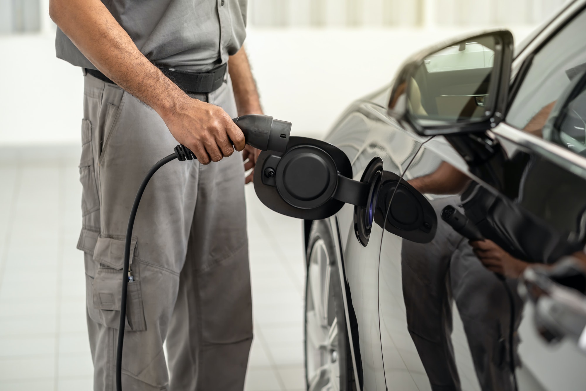 closeup-asian-technician-hand-is-charging-the-electric-car-or-ev-in-service-center.jpg